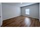 Spacious bedroom with wood-look floors and a window with blinds at 163 Marsh Deer Place, Surfside Beach, SC 29575