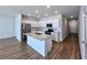 Modern kitchen with white cabinets, granite island, and stainless steel appliances at 163 Marsh Deer Place, Surfside Beach, SC 29575