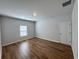 Simple bedroom with wood-look floors and a window with blinds at 163 Marsh Deer Place, Surfside Beach, SC 29575