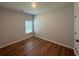 Simple bedroom with wood-look floors and a window at 163 Marsh Deer Place, Surfside Beach, SC 29575