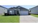 Gray house with white garage and green lawn at 163 Marsh Deer Place, Surfside Beach, SC 29575
