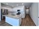 Modern kitchen with white cabinets, granite island, and stainless steel appliances at 163 Marsh Deer Place, Surfside Beach, SC 29575