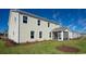 Two-story house with beige siding, landscaped yard, and screened porch at 7043 Shooting Star Way, Myrtle Beach, SC 29579