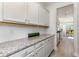 Kitchen features granite countertops and white cabinets at 7043 Shooting Star Way, Myrtle Beach, SC 29579