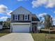 Two-story house with gray siding, white accents, and a two-car garage at 2635 Riverboat Way, Conway, SC 29526