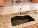 Close-up of a black kitchen sink and granite countertop at 160 Lazy Willow Ln. # 204, Myrtle Beach, SC 29588