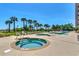 Resort-style pool and hot tub area with lounge chairs at 5310 N Ocean Blvd. # 301, Myrtle Beach, SC 29577
