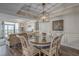 Elegant dining area with a round table and four chairs, overlooking the living room at 5310 N Ocean Blvd. # 301, Myrtle Beach, SC 29577