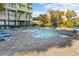 Hotel pool area with lounge chairs and palm trees at 1105 S Ocean Blvd. # 228, Myrtle Beach, SC 29577