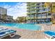 Resort-style pool with ample lounge chairs and surrounding buildings at 1105 S Ocean Blvd. # 228, Myrtle Beach, SC 29577
