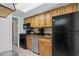 Compact kitchen with dark appliances and wood cabinets at 1105 S Ocean Blvd. # 228, Myrtle Beach, SC 29577