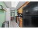 Kitchen with granite counters, black appliances, and access to bedroom at 1105 S Ocean Blvd. # 228, Myrtle Beach, SC 29577