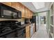 Well-equipped kitchen featuring granite countertops and black appliances at 1105 S Ocean Blvd. # 228, Myrtle Beach, SC 29577