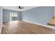 Spacious living room with wood-look floors and balcony access at 1301 Pridgen Rd. # 105, Myrtle Beach, SC 29577