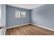 Simple bedroom with wood-look floors and window at 1301 Pridgen Rd. # 105, Myrtle Beach, SC 29577