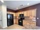 Kitchen with light wood cabinets, black appliances, and tile floors at 709 Ashley Manor Dr., Longs, SC 29568