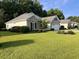 House exterior showcasing a ranch style home with a well maintained lawn at 709 Ashley Manor Dr., Longs, SC 29568