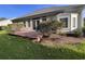 Back of house showcasing a deck and well maintained landscaping at 709 Ashley Manor Dr., Longs, SC 29568