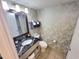 Bathroom with granite vanity and patterned walls at 2000 N Ocean Blvd. # 503, Myrtle Beach, SC 29577
