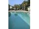 Inviting community pool with lounge chairs and palm trees at 517 White River Dr. # 22H, Myrtle Beach, SC 29579