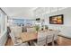 Light-filled dining area with wooden table and ocean view at 1919 South Waccamaw Dr., Garden City Beach, SC 29576