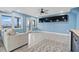 Spacious basement with tiled floors, a sofa, and large TV at 1919 South Waccamaw Dr., Garden City Beach, SC 29576