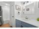 Simple bathroom with light blue vanity and shower/tub combo at 1919 South Waccamaw Dr., Garden City Beach, SC 29576
