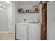 Convenient laundry room with washer, dryer, and shelving at 1919 South Waccamaw Dr., Garden City Beach, SC 29576