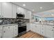 Modern kitchen with stainless steel appliances and granite countertops at 1919 South Waccamaw Dr., Garden City Beach, SC 29576
