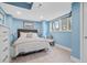 Cozy bedroom with a queen-size bed and light blue walls at 1919 South Waccamaw Dr., Garden City Beach, SC 29576