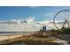 Stunning beachfront view with a Ferris wheel and pier in the distance at 533 Black Pearl Way, Myrtle Beach, SC 29588