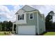 Two-story house, green siding, white garage door, and landscaping at 2616 Riverboat Way, Conway, SC 29526