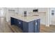 Modern kitchen with a large navy blue island and white cabinets at 1958 Woodrush Loop, Little River, SC 29566