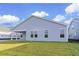 Rear view of light blue house featuring covered patio and backyard at 1958 Woodrush Loop, Little River, SC 29566