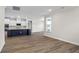Open concept living and dining area with hardwood floors and kitchen island at 1958 Woodrush Loop, Little River, SC 29566