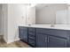 Double vanity bathroom with dark blue cabinets and gold fixtures at 1958 Woodrush Loop, Little River, SC 29566