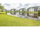 Tranquil pond reflecting charming townhouses, lush green grass, and scenic landscaping at 4917 Twin Pond Ct. # 102, Myrtle Beach, SC 29579