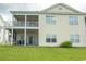 Two-story townhouse with a large screened porch and deck, surrounded by a well-manicured lawn at 4917 Twin Pond Ct. # 102, Myrtle Beach, SC 29579