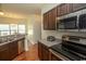 Kitchen with stainless steel appliances and dark wood cabinets at 4917 Twin Pond Ct. # 102, Myrtle Beach, SC 29579