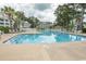 Resort-style pool with plenty of lounge chairs and umbrellas at 4917 Twin Pond Ct. # 102, Myrtle Beach, SC 29579