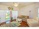 Living room with hardwood floors, ceiling fan, and access to patio at 4917 Twin Pond Ct. # 102, Myrtle Beach, SC 29579