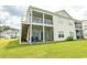 Ground-level patio with screened porch and stairs to second-story deck at 4917 Twin Pond Ct. # 102, Myrtle Beach, SC 29579