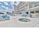 Community pool and hot tub with lounge chairs at 3401 N Ocean Blvd. # 306, North Myrtle Beach, SC 29582