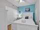 Bedroom with queen bed, light blue accent wall and white dresser at 3401 N Ocean Blvd. # 306, North Myrtle Beach, SC 29582
