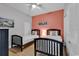 Bedroom with two twin beds, coral accent wall, and ceiling fan at 3401 N Ocean Blvd. # 306, North Myrtle Beach, SC 29582