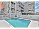 Inviting community pool with surrounding patio and building views at 3401 N Ocean Blvd. # 306, North Myrtle Beach, SC 29582