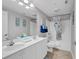 Bathroom with double vanity, shower/tub combo, and beach themed decor at 3401 N Ocean Blvd. # 306, North Myrtle Beach, SC 29582