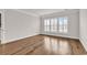 Bright bedroom with hardwood floors and large windows at 6620 Pozzallo Place, Myrtle Beach, SC 29572