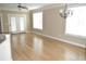 Light-filled living room with hardwood floors and access to patio at 144 Puffin Dr. # 2-E, Pawleys Island, SC 29585
