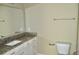 Bathroom boasts granite countertop, white cabinets, and a large mirror at 144 Puffin Dr. # 2-E, Pawleys Island, SC 29585